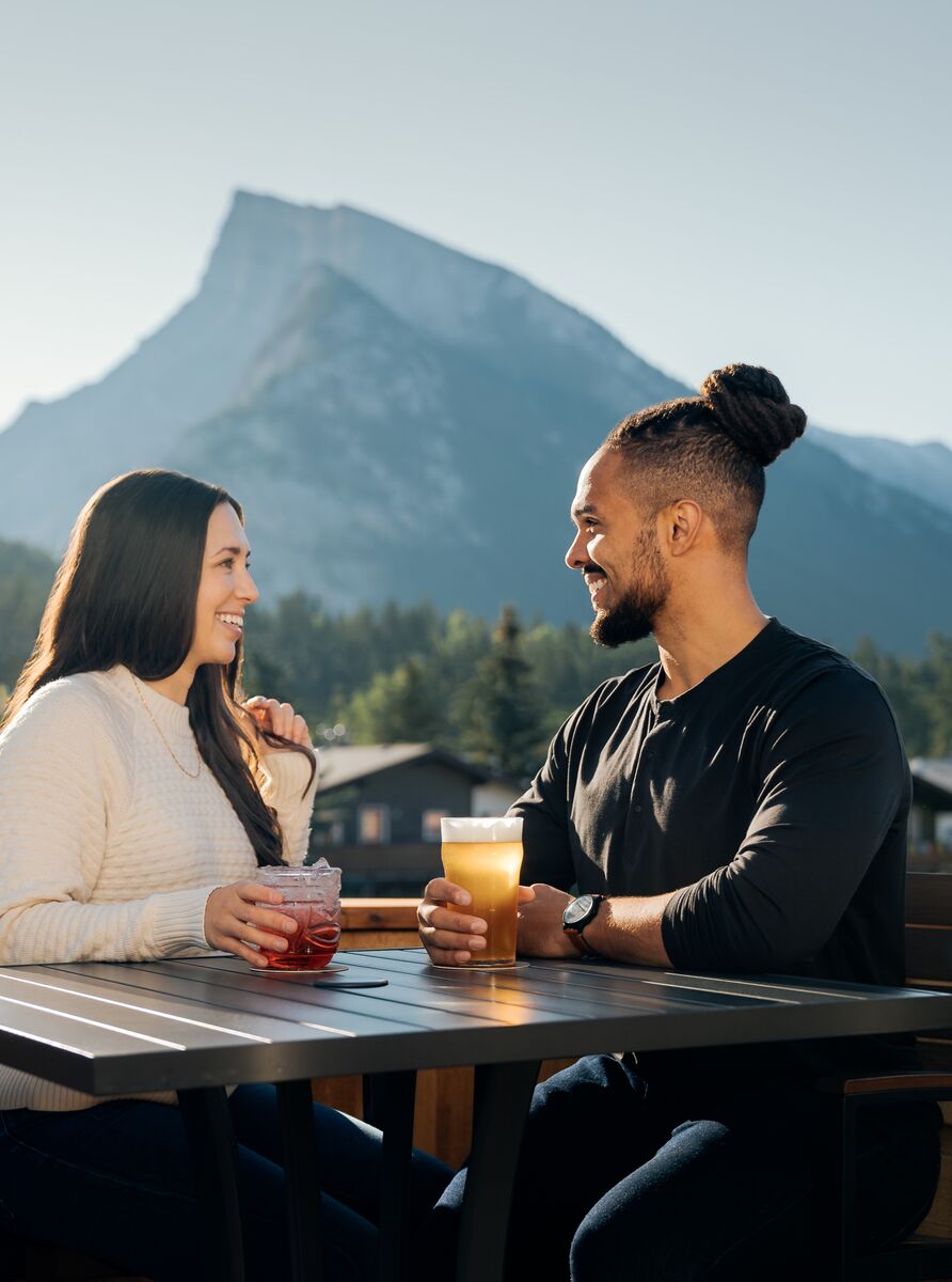 Couple enjoying a drink on an outdoor patio in the summer